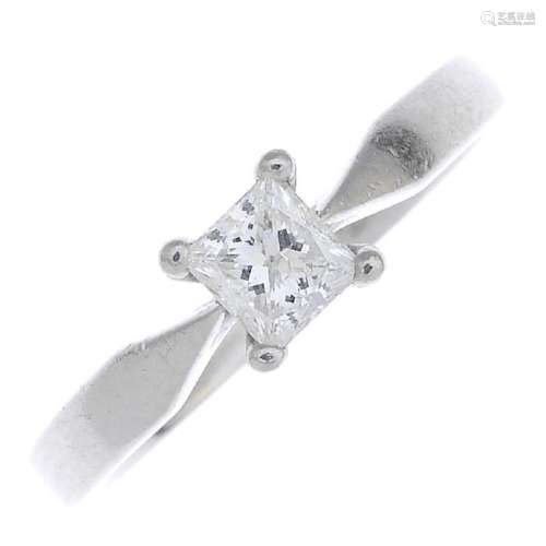 A platinum diamond single-stone ring. The square-shape