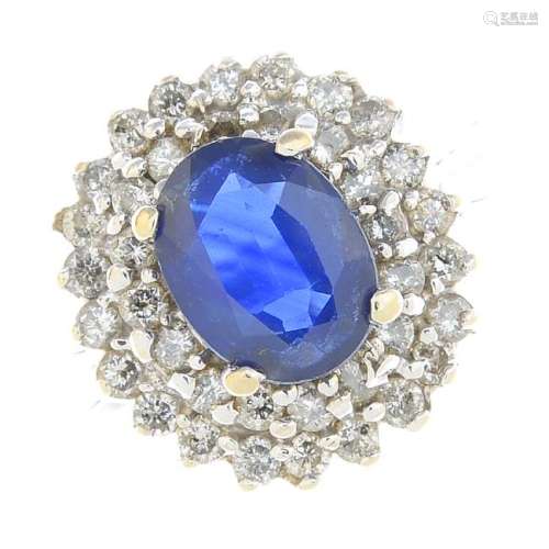 A sapphire and diamond cluster ring. The oval-shape