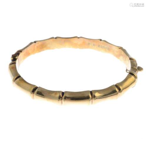 A 1970s 9ct gold bangle. Designed as a hinged bangle,