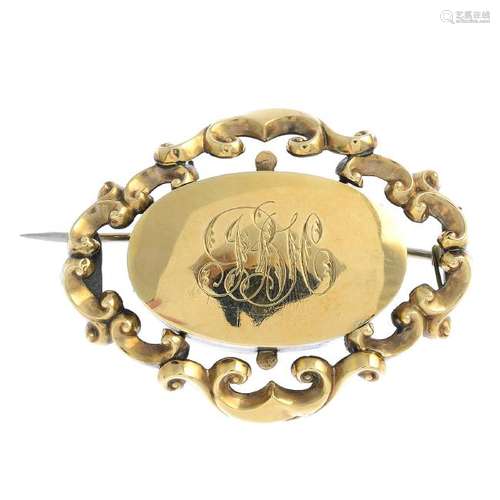 A late Victorian gold brooch. The engraved monogram