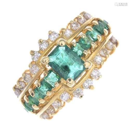 A 14ct gold emerald and diamond ring. The