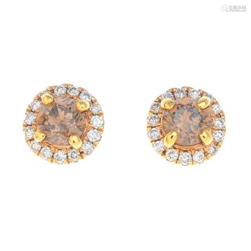 A pair of coloured diamond and diamond earrings. Each