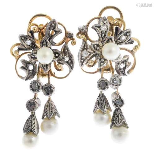 A pair of diamond and cultured pearl earrings. Each