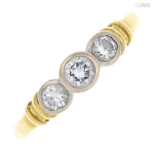 An 18ct gold diamond three-stone ring. The