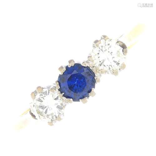 A sapphire and diamond three-stone ring. The