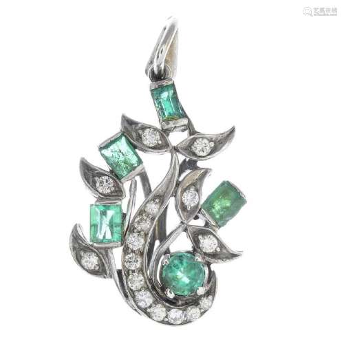 A diamond and emerald pendant. Of openwork design, the