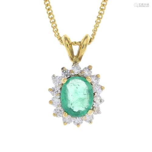 An 18ct gold emerald and diamond pendant. The