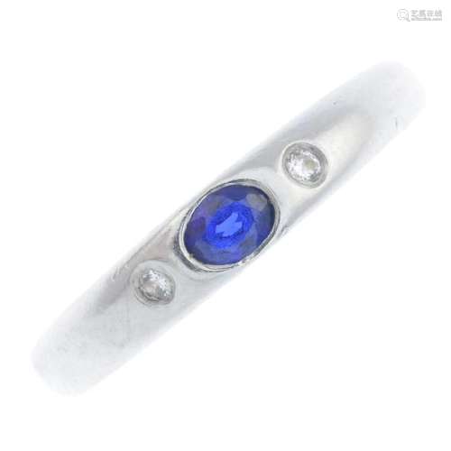 A platinum sapphire and diamond ring. The oval-shape