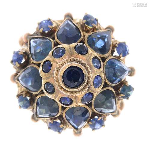 A sapphire cluster ring. Of cone design, the