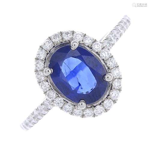 A sapphire and diamond dress ring. The oval-shape