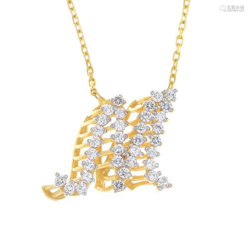 A diamond pendant. The pave-set diamond stylised 'M',