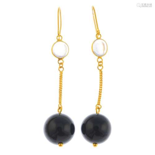 A pair of moonstone and onyx earrings. Each designed as