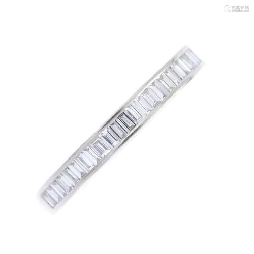 A diamond half eternity ring. The baguette-cut diamond