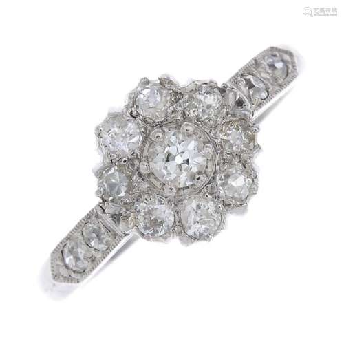 A diamond cluster ring. The old-cut diamond, within a