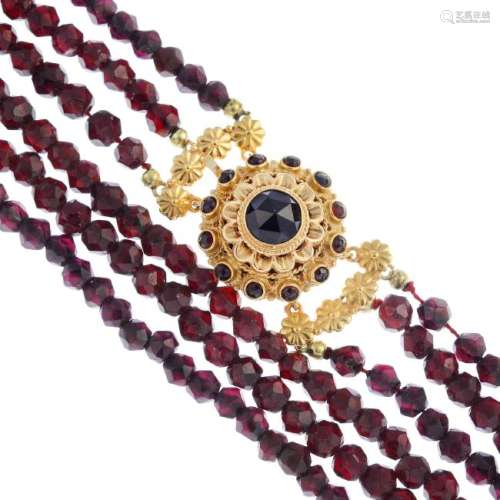 A garnet three-row necklace. Comprising three rows of