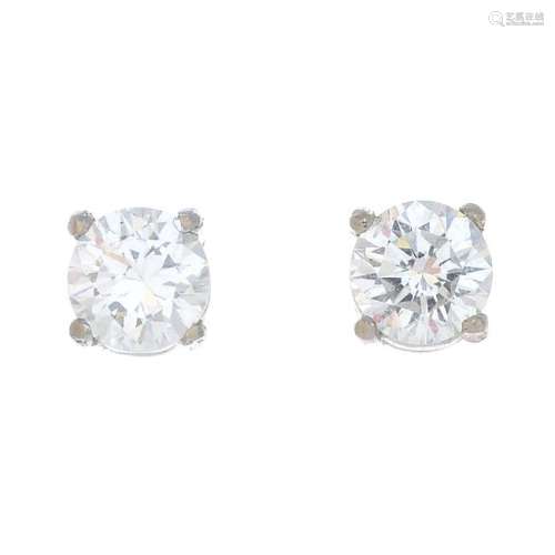 A pair of brilliant-cut diamond stud earrings.