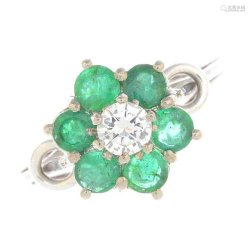 A diamond and emerald cluster ring. Designed as a