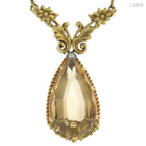 A citrine and diamond pendant. The pear-shape citrine,