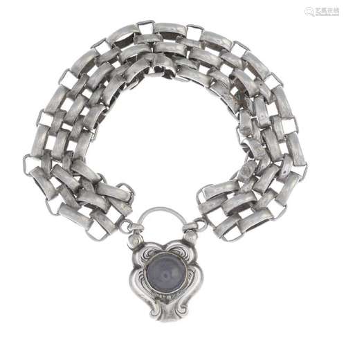 A brick-link bracelet, suspending an interwoven hair