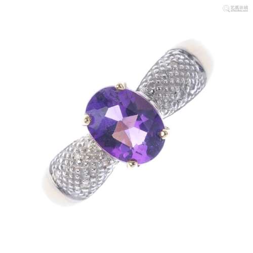 A 9ct gold amethyst and diamond ring. The oval-shape