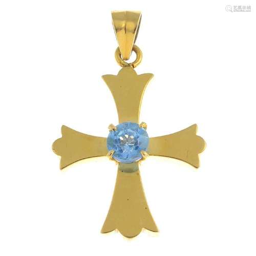 A topaz cross pendant. The round topaz, set atop the