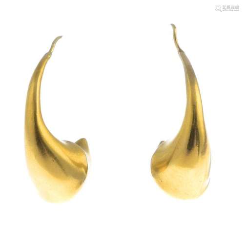 A pair of earrings. Each designed as a stylised horn,