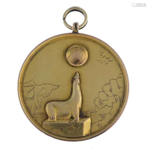 An early 20th century gold sea lion medallion. Of