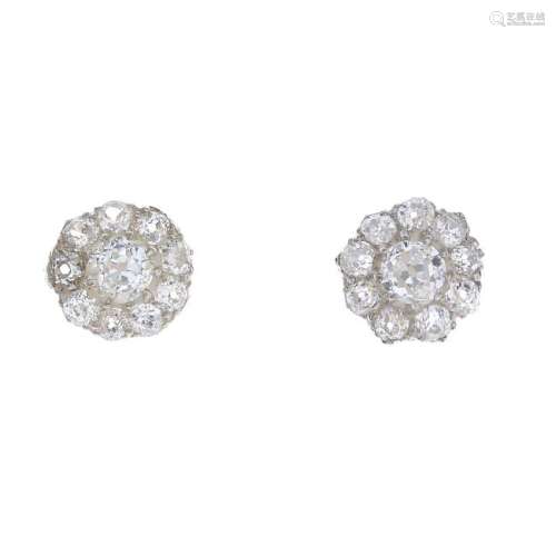 A pair of diamond cluster earrings. Each designed as an