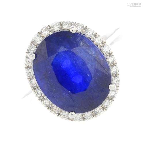 A glass-filled sapphire and diamond cluster ring. The