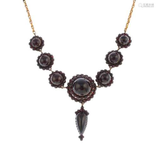 A mid Victorian silver and gold garnet necklace. The