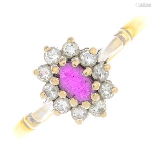 An 18ct gold ruby and diamond cluster ring. The
