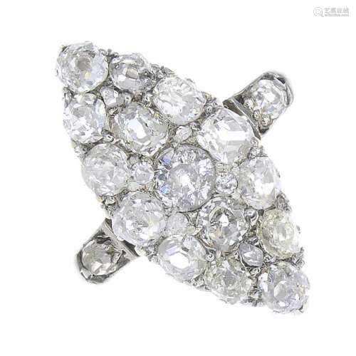 A diamond cluster ring. The old-cut diamond line, with