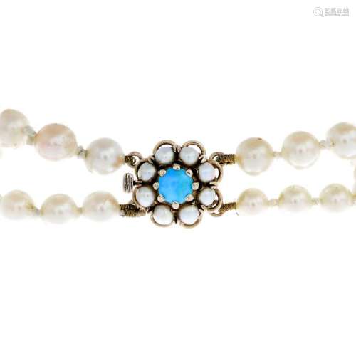 A cultured pearl two-row bracelet. Each row comprising