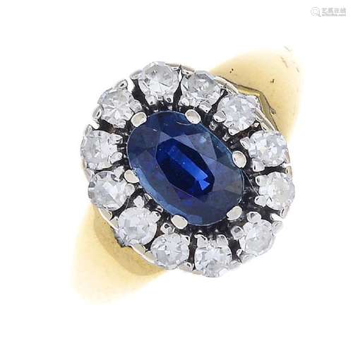 A sapphire and diamond cluster ring. The oval-shape