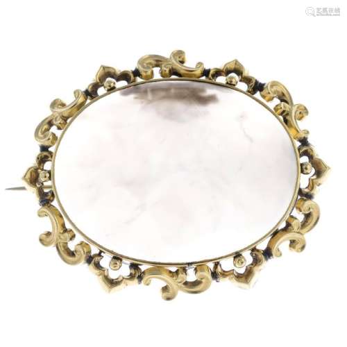 A late Victorian gold chalcedony brooch. The oval white