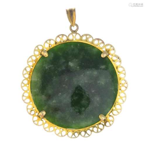A jade pendant. The shallow cabochon jade disc, with