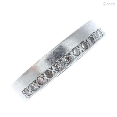 A platinum diamond band ring. The brilliant-cut diamond