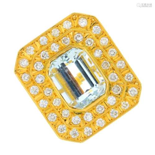 An 18ct gold aquamarine and diamond ring. The