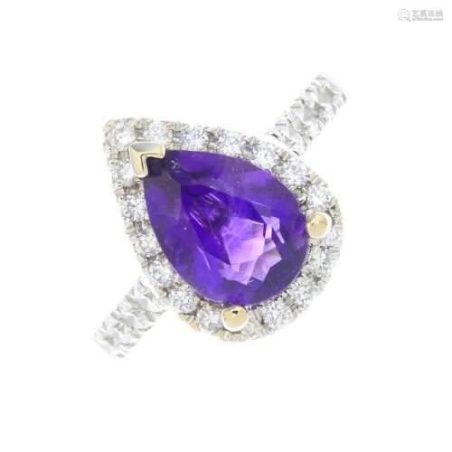 An 18ct gold amethyst and diamond cluster ring. The