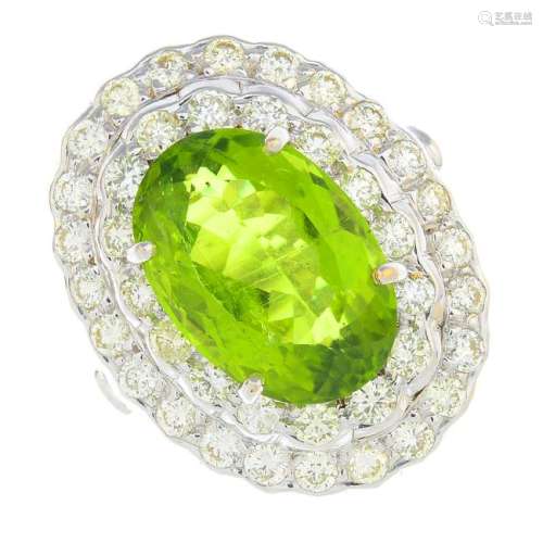 A peridot and diamond cluster ring. The oval-shape