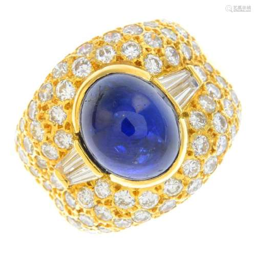 A sapphire and diamond ring. Designed as an oval