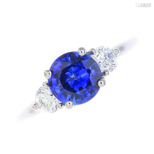 An 18ct gold sapphire and diamond three-stone ring. The
