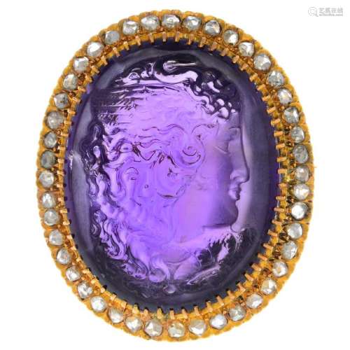 An amethyst and diamond cameo brooch. The oval