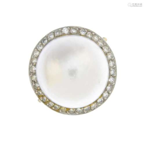 An 18ct gold mabe pearl and diamond dress ring. The