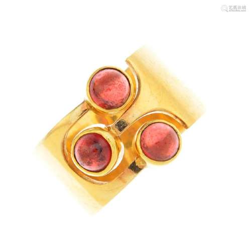 A 14ct gold garnet dress ring. The open band, with