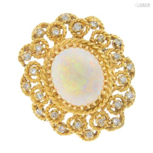 An opal and diamond cluster ring. Of openwork design,