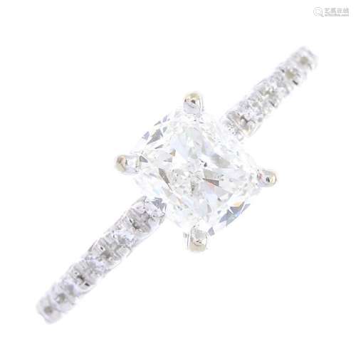 A diamond single-stone ring. The cushion-shape diamond,