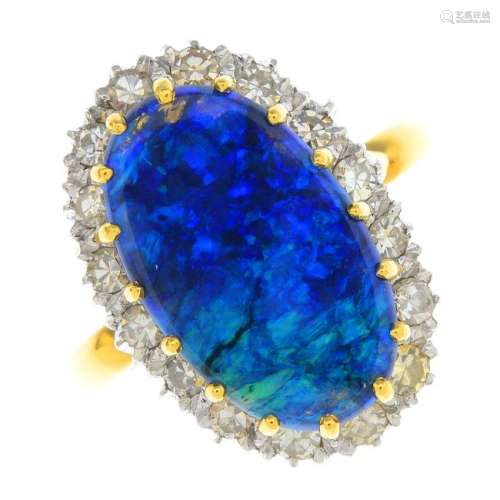 An opal and diamond cluster ring. The oval opal
