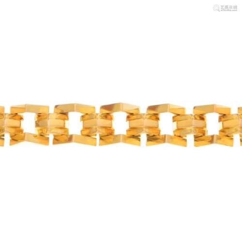 A bracelet. Designed as a triangular brick-link chain.