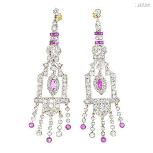 A pair of ruby and diamond earrings. Each designed as a
